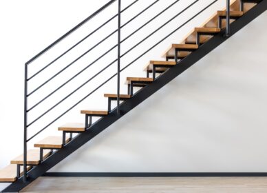 Modern loft staircase. Wooden steps and metal railings. Minimalist interior.